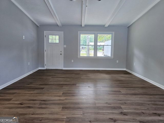 entrance foyer with dark wood-type flooring, beam ceiling, and plenty of natural light