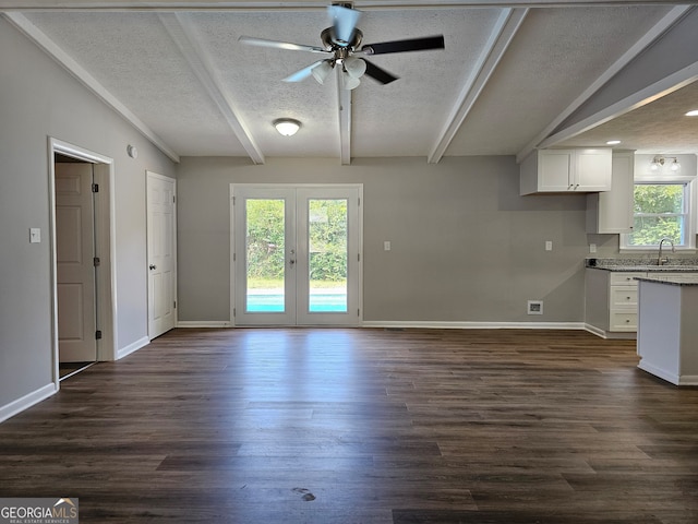 interior space featuring french doors, a textured ceiling, dark wood-type flooring, and ceiling fan