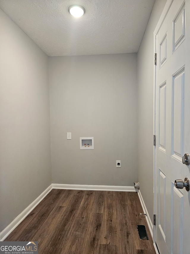 washroom with hookup for an electric dryer, a textured ceiling, washer hookup, and dark hardwood / wood-style flooring