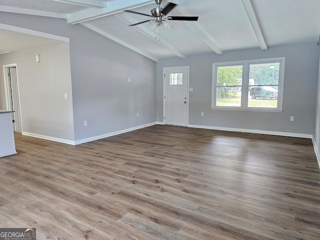 unfurnished living room with light hardwood / wood-style flooring, lofted ceiling with beams, and ceiling fan