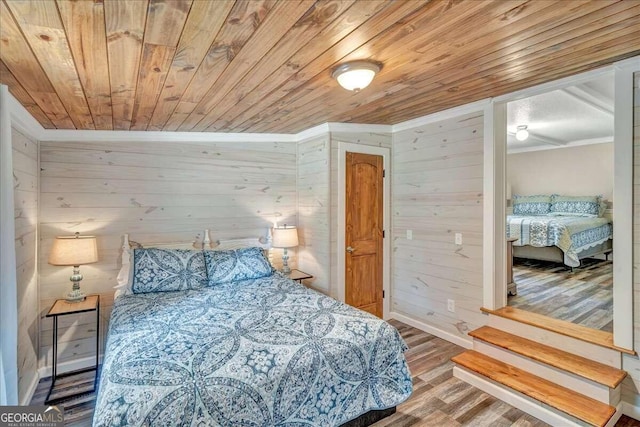 bedroom featuring ornamental molding, wood ceiling, hardwood / wood-style flooring, and wooden walls