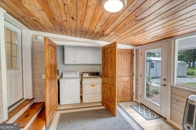 interior space with wooden ceiling, washer and clothes dryer, and wooden walls