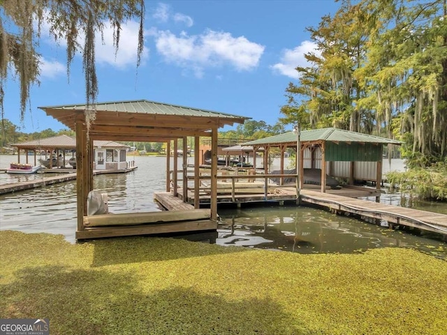 dock area featuring a water view and a yard