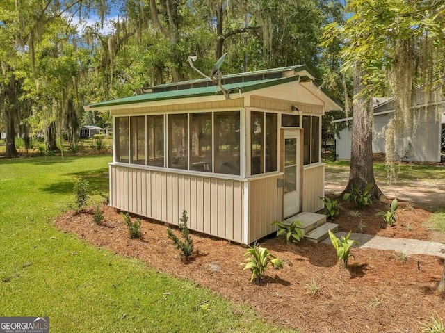 view of property exterior with a lawn and a sunroom