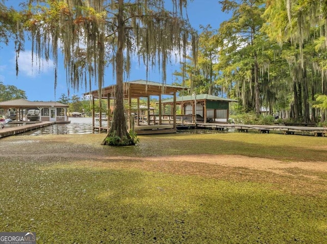 view of community featuring a yard and a water view