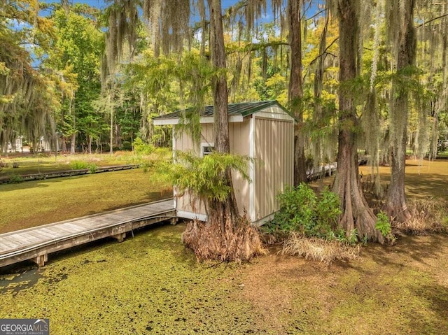 view of yard with a wooden deck and a shed