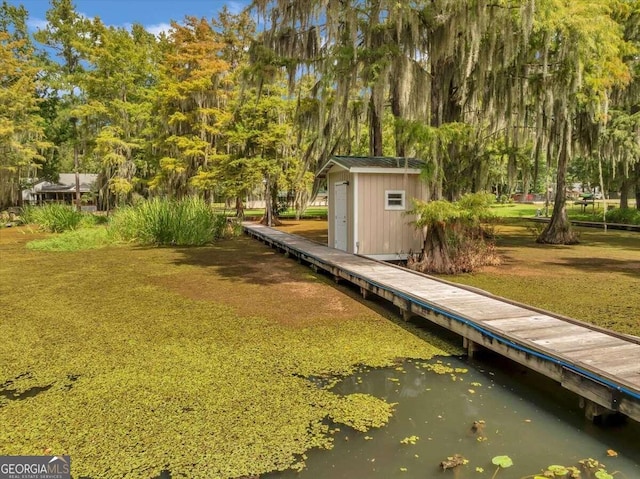 exterior space featuring a water view and a storage unit