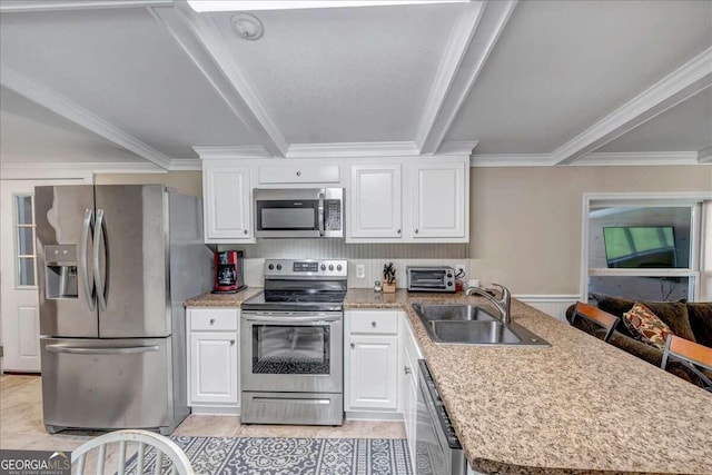 kitchen featuring crown molding, white cabinetry, stainless steel appliances, and sink