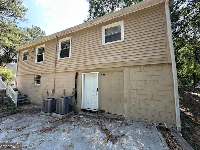 rear view of house featuring central AC unit