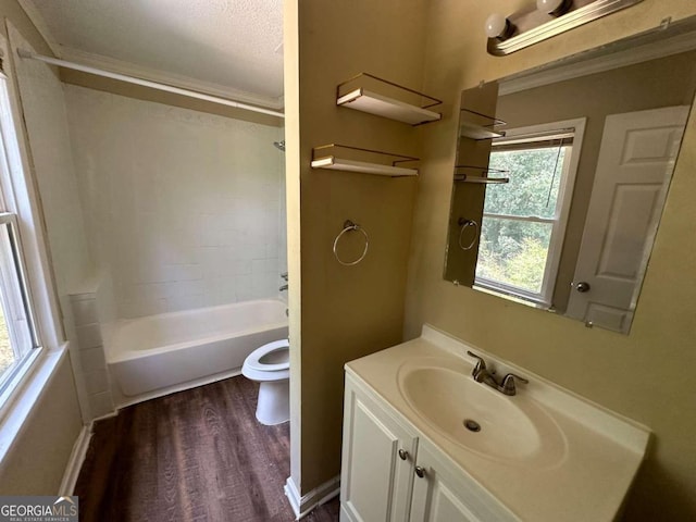 full bathroom featuring a wealth of natural light, vanity, toilet, and tub / shower combination