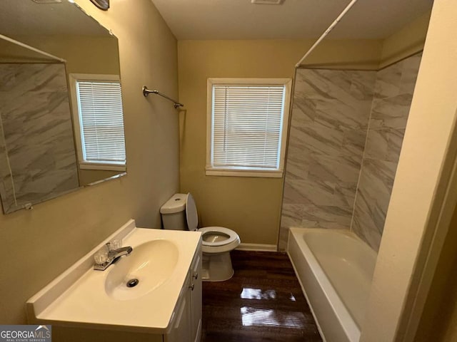 full bathroom with vanity, toilet, hardwood / wood-style flooring, and tiled shower / bath