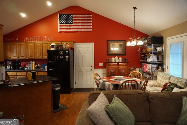 living room featuring high vaulted ceiling, a chandelier, and dark hardwood / wood-style flooring