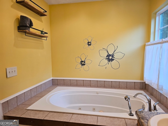 bathroom with sink and tiled bath