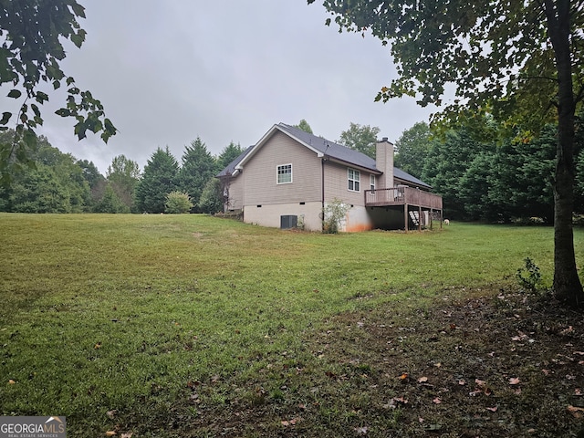 view of side of property featuring a lawn, a wooden deck, and cooling unit