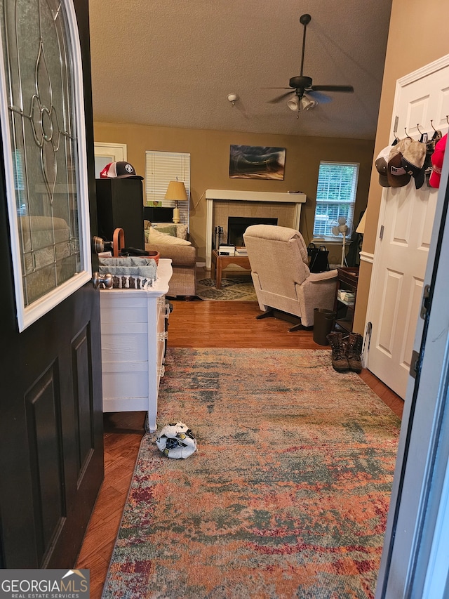 kitchen featuring light hardwood / wood-style floors, vaulted ceiling, a textured ceiling, and black fridge