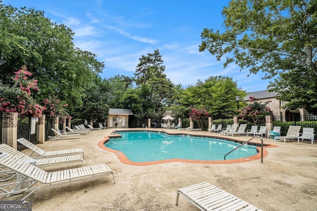 view of pool with a patio area and an outbuilding