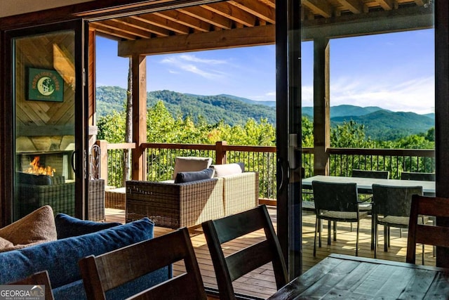 balcony with a deck with mountain view and an outdoor hangout area