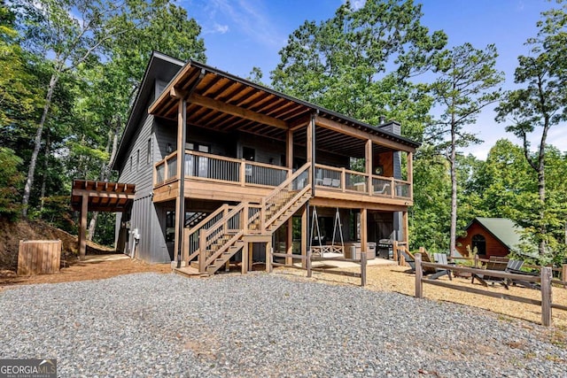 view of front of property with a deck and a patio