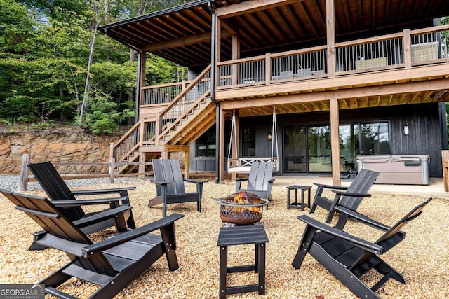 view of patio with a fire pit and a wooden deck