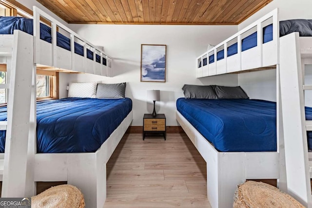 bedroom with wooden ceiling and light hardwood / wood-style floors