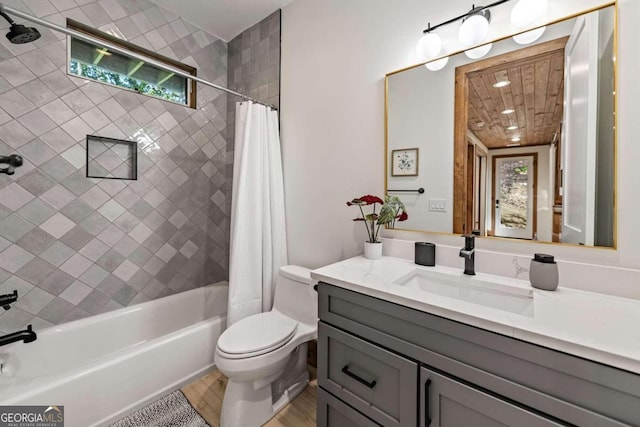 full bathroom with shower / bathtub combination with curtain, toilet, hardwood / wood-style flooring, and vanity