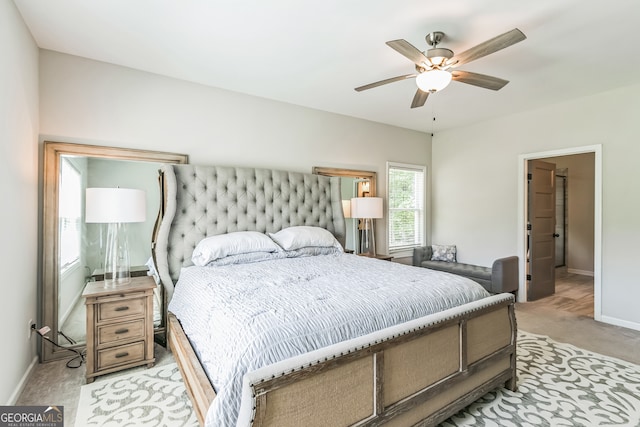 bedroom featuring light carpet and ceiling fan