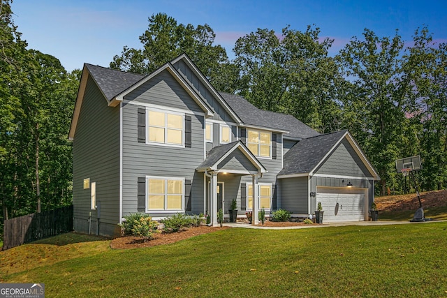 view of front of home with a garage and a lawn