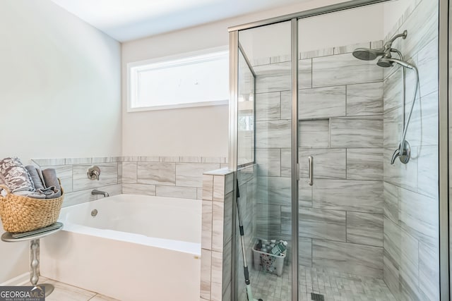 bathroom featuring independent shower and bath