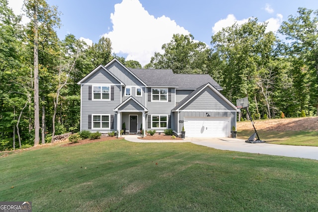 view of front of property featuring a garage and a front yard