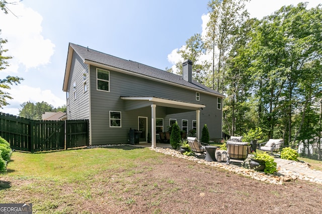 rear view of house with a patio area and a yard