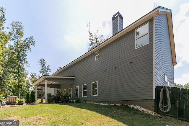 rear view of property with a lawn