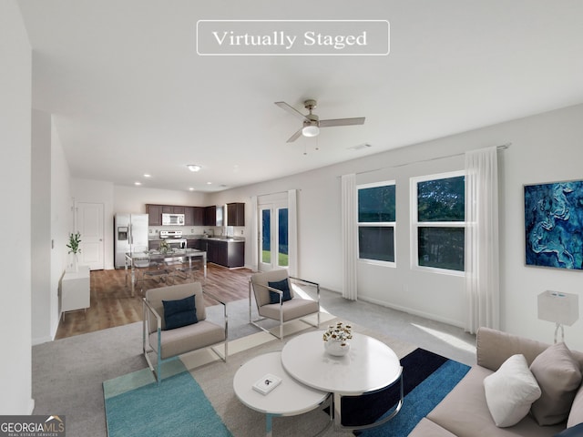 living area featuring visible vents, recessed lighting, light wood finished floors, baseboards, and ceiling fan