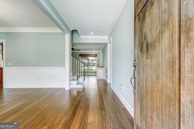 interior space featuring crown molding, a textured ceiling, hardwood / wood-style floors, and ceiling fan