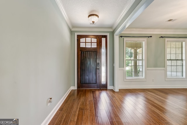 foyer with a textured ceiling, ornamental molding, and wood-type flooring