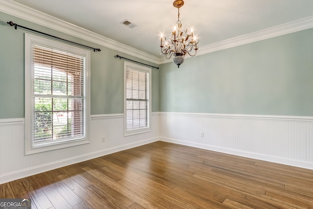 unfurnished room with crown molding, a chandelier, and hardwood / wood-style floors