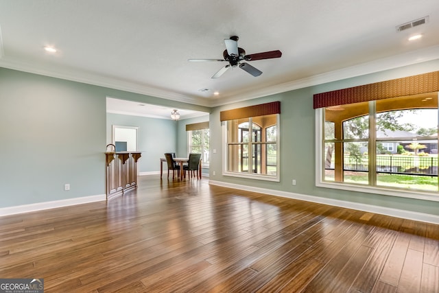 unfurnished living room with dark wood-type flooring, ceiling fan, and ornamental molding