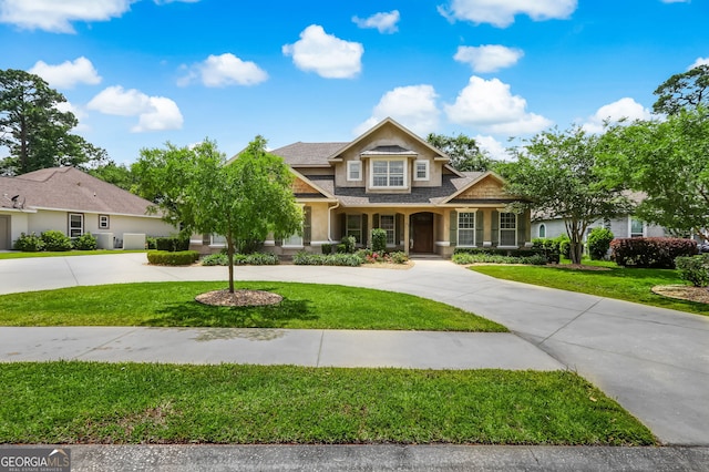 craftsman inspired home with a front lawn