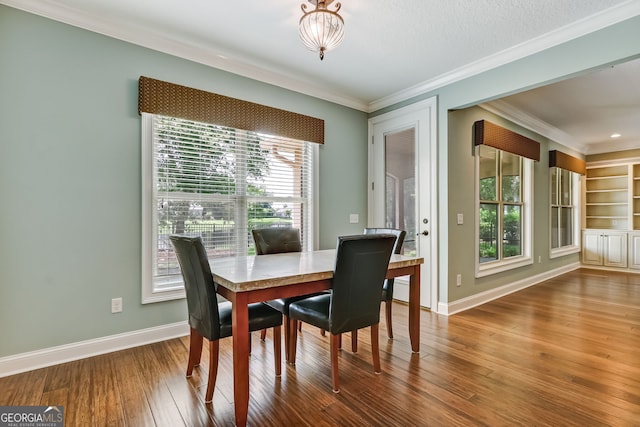 dining room featuring ornamental molding and dark hardwood / wood-style flooring