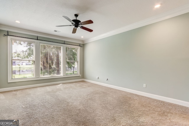 carpeted empty room featuring a textured ceiling, ceiling fan, and ornamental molding