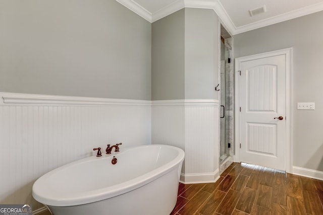 bathroom with crown molding, separate shower and tub, and hardwood / wood-style flooring