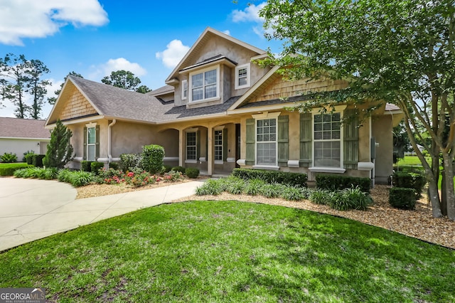 view of front of home with a porch and a front lawn