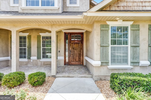 view of exterior entry with a porch