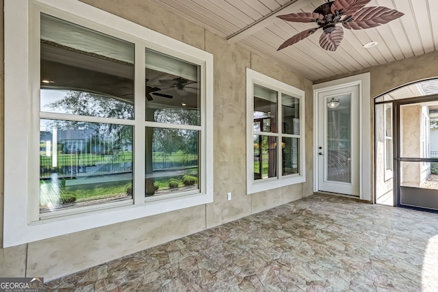 exterior space featuring wood ceiling, a wealth of natural light, and ceiling fan