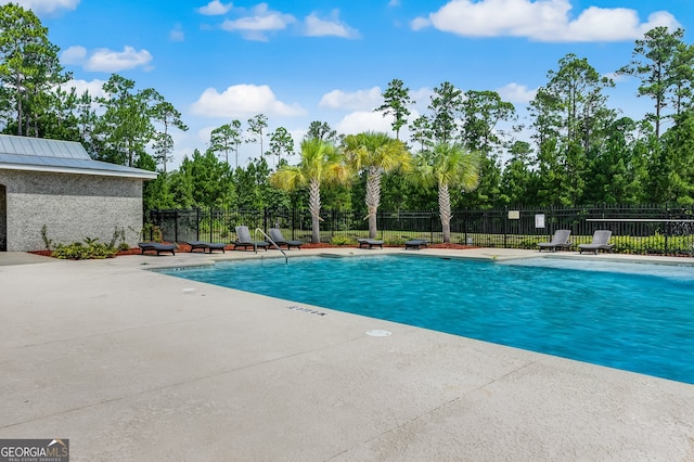 view of swimming pool featuring a patio area