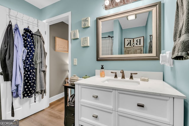 bathroom featuring vanity, hardwood / wood-style flooring, and curtained shower