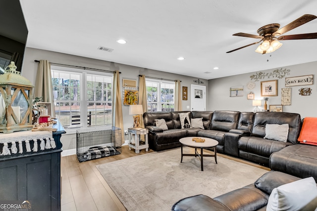 living room featuring light wood-type flooring and ceiling fan