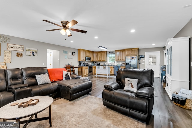 living room with ceiling fan and light hardwood / wood-style floors