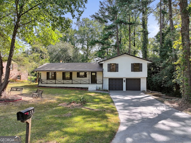 split level home with a garage, a front yard, and a porch