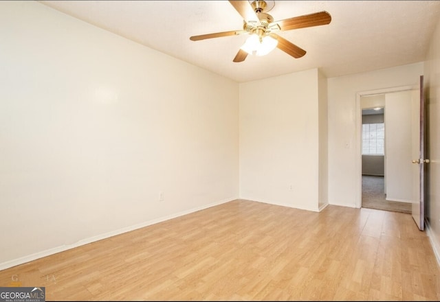 spare room featuring light wood-type flooring and ceiling fan