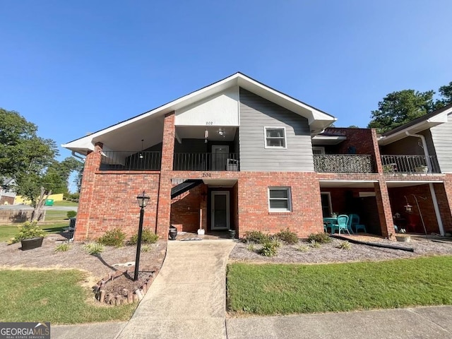 back of property featuring a yard and a balcony